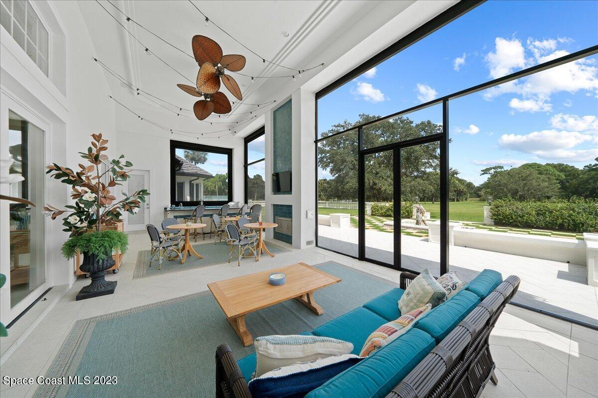 2815 Turtle Mound Road Melbourne, FL 32934 - Photo 61 of 115 a living room with patio furniture and a chandelier