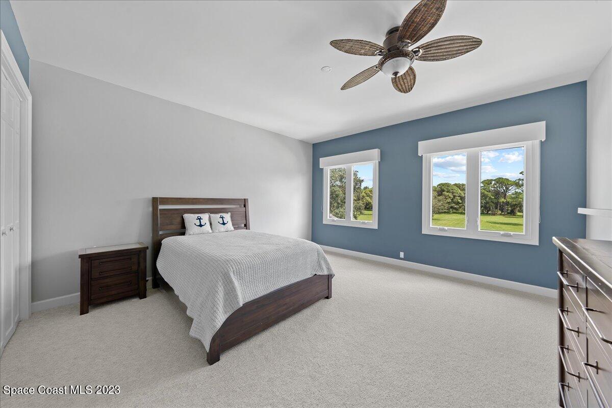 2815 Turtle Mound Road Melbourne, FL 32934 - Photo 64 of 115 a spacious bedroom with a bed and a window