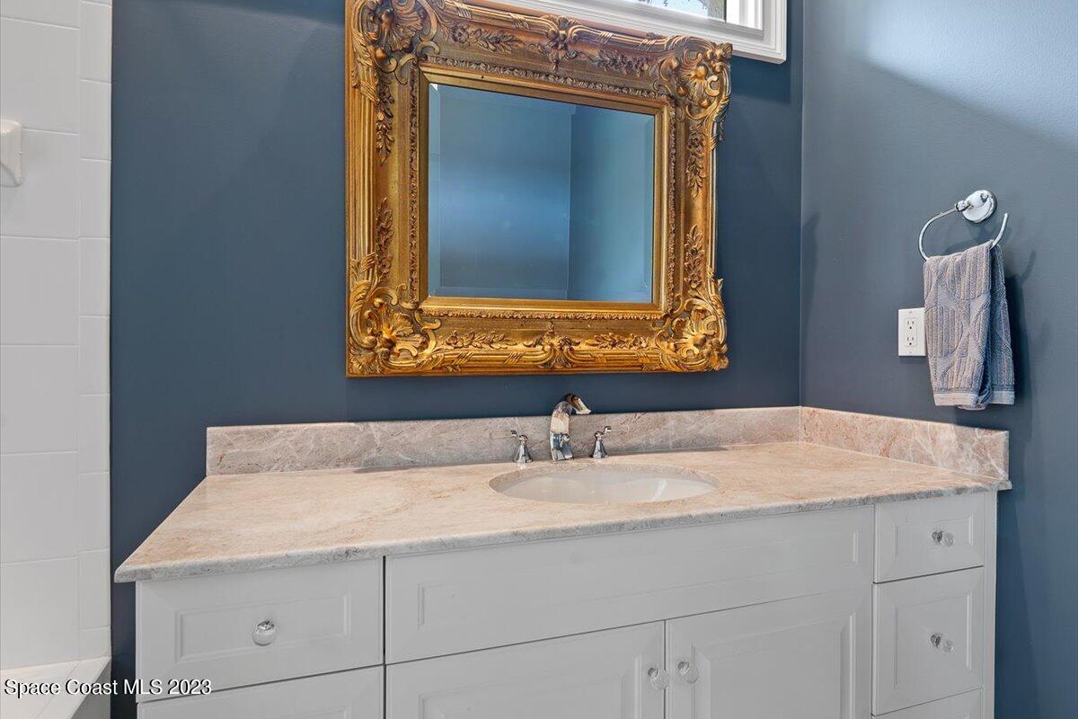 2815 Turtle Mound Road Melbourne, FL 32934 - Photo 72 of 115 a bathroom with a sink vanity and a mirror