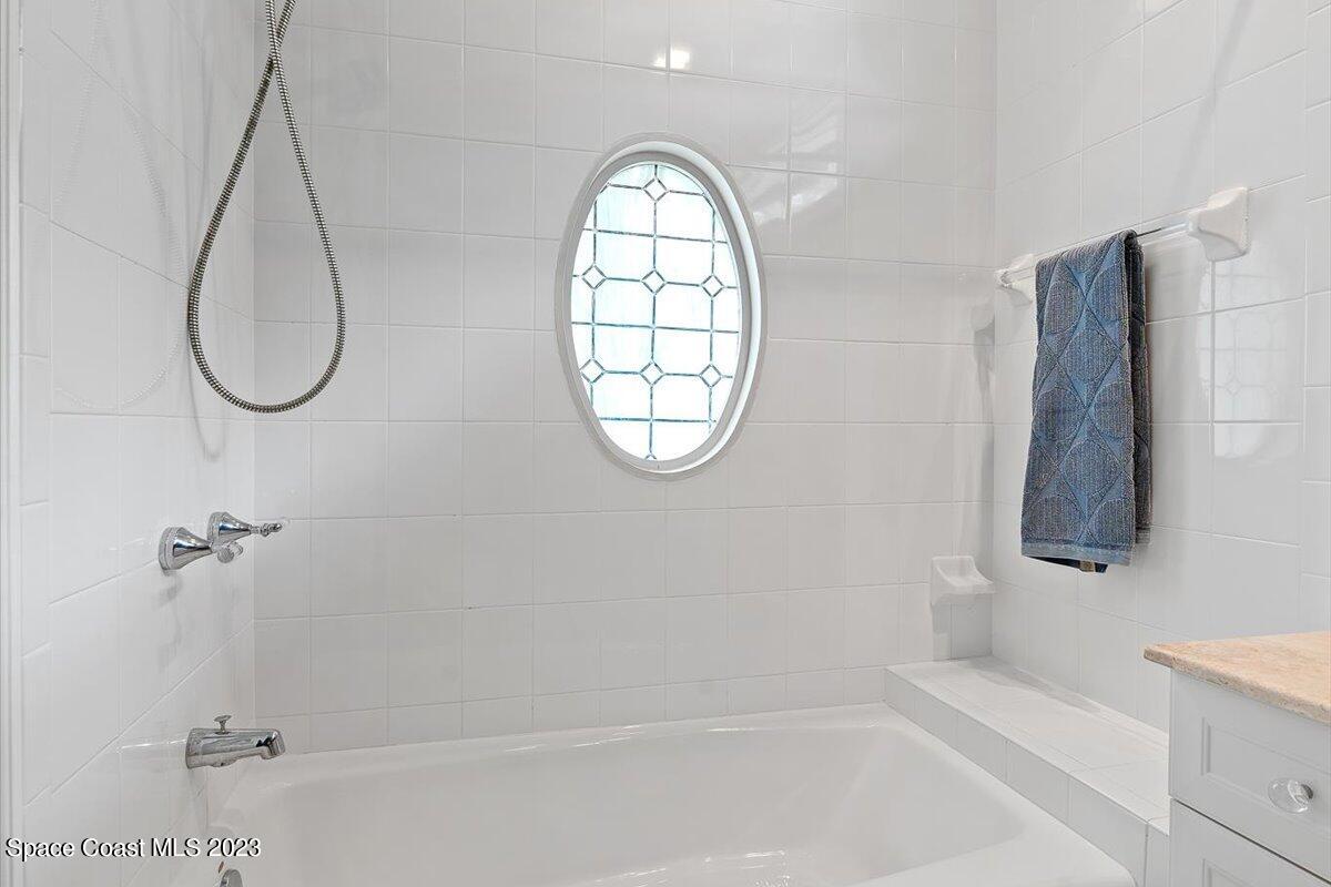 2815 Turtle Mound Road Melbourne, FL 32934 - Photo 73 of 115 a bathroom with a sink a mirror and a window