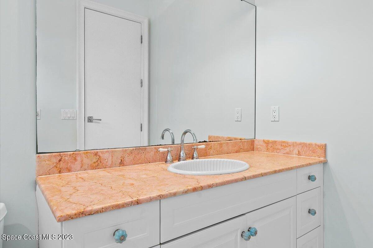 2815 Turtle Mound Road Melbourne, FL 32934 - Photo 76 of 115 a bathroom with a sink and a mirror