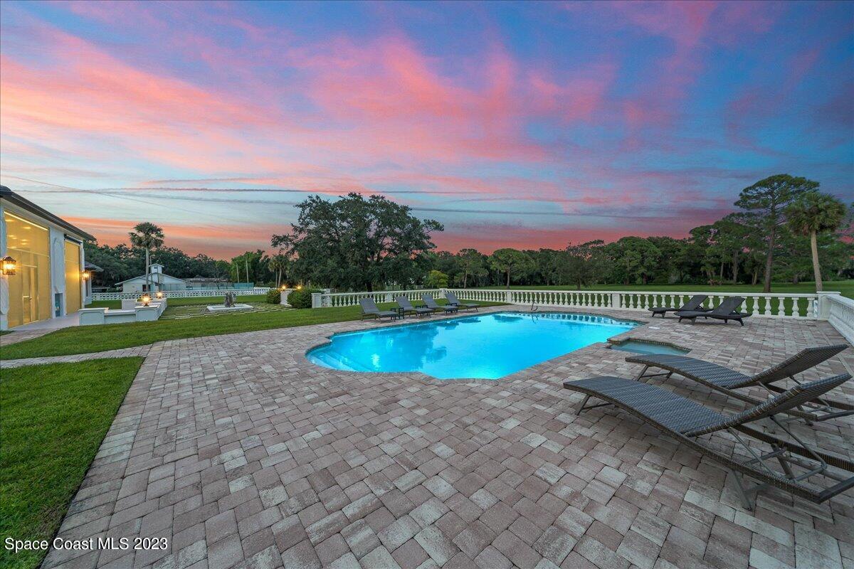 2815 Turtle Mound Road Melbourne, FL 32934 - Photo 78 of 115 a view of a swimming pool with an outdoor space and seating area