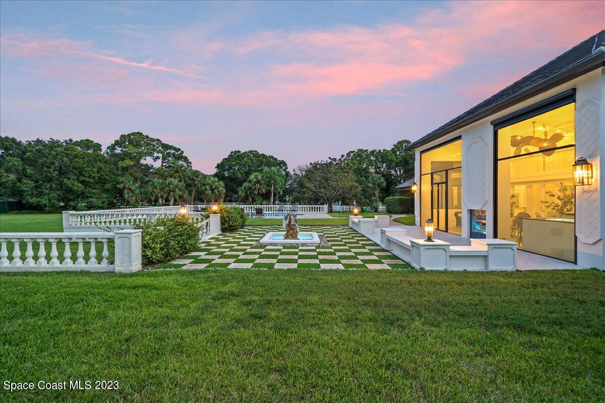 2815 Turtle Mound Road Melbourne, FL 32934 - Photo 83 of 115 a view of a house with a backyard porch and sitting area