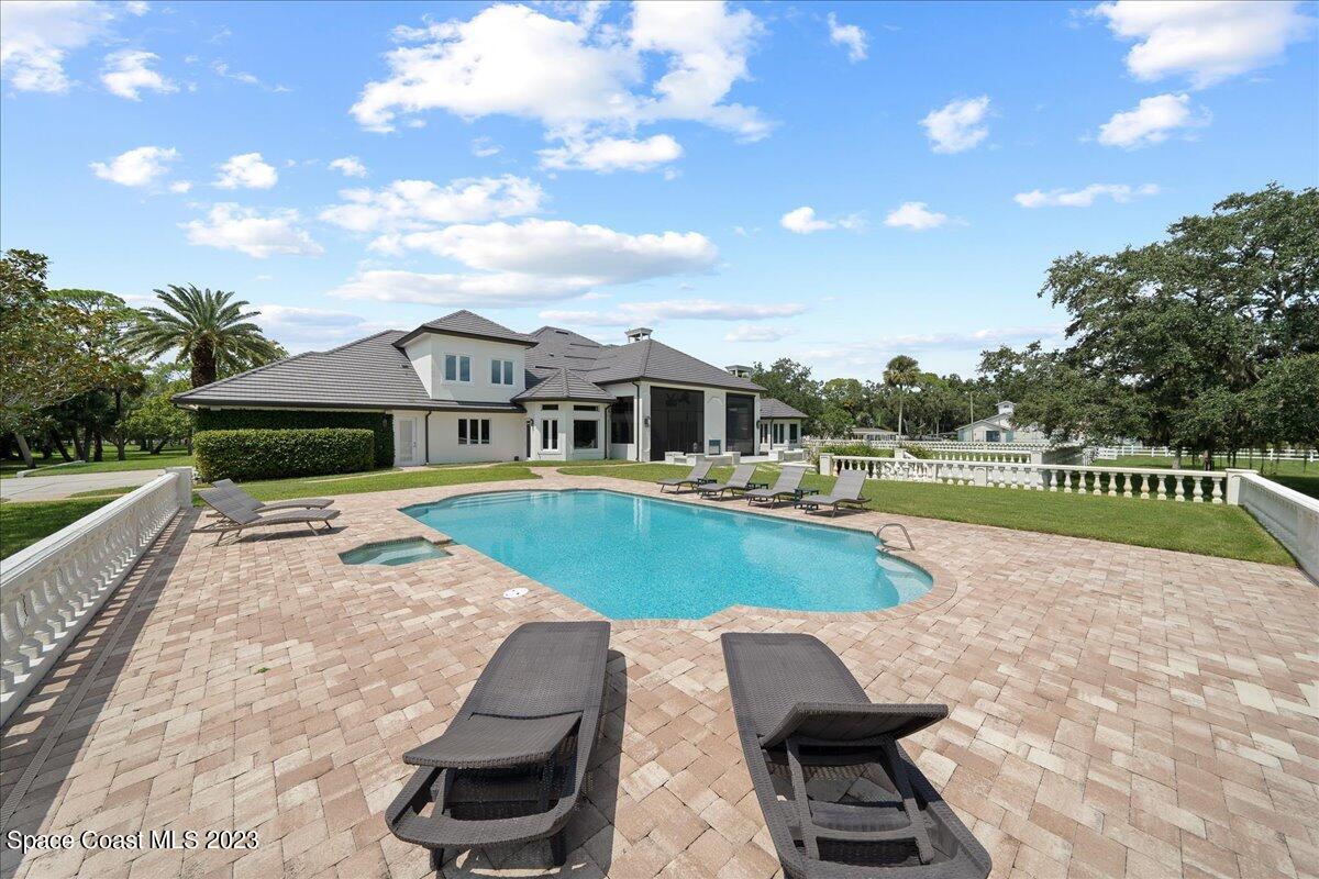 2815 Turtle Mound Road Melbourne, FL 32934 - Photo 86 of 115 a view of a house with swimming pool and a yard