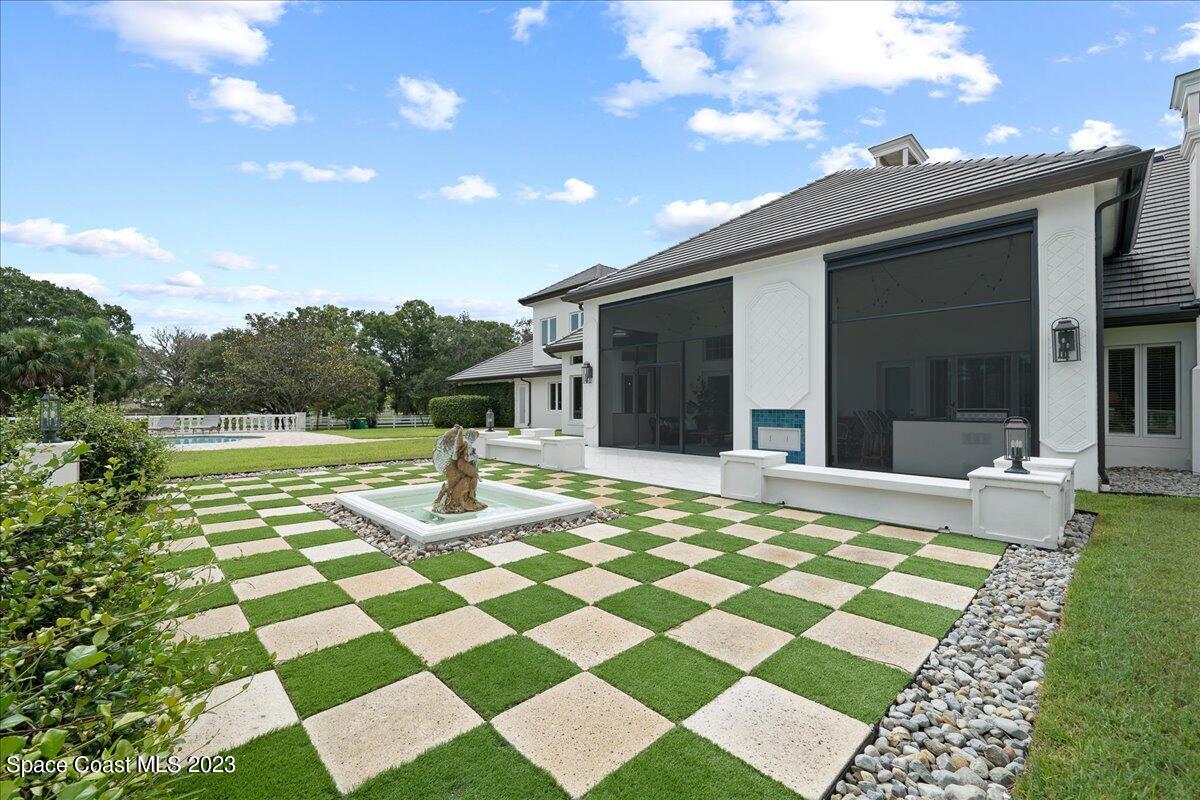 2815 Turtle Mound Road Melbourne, FL 32934 - Photo 91 of 115 a view of a patio with a table and chairs