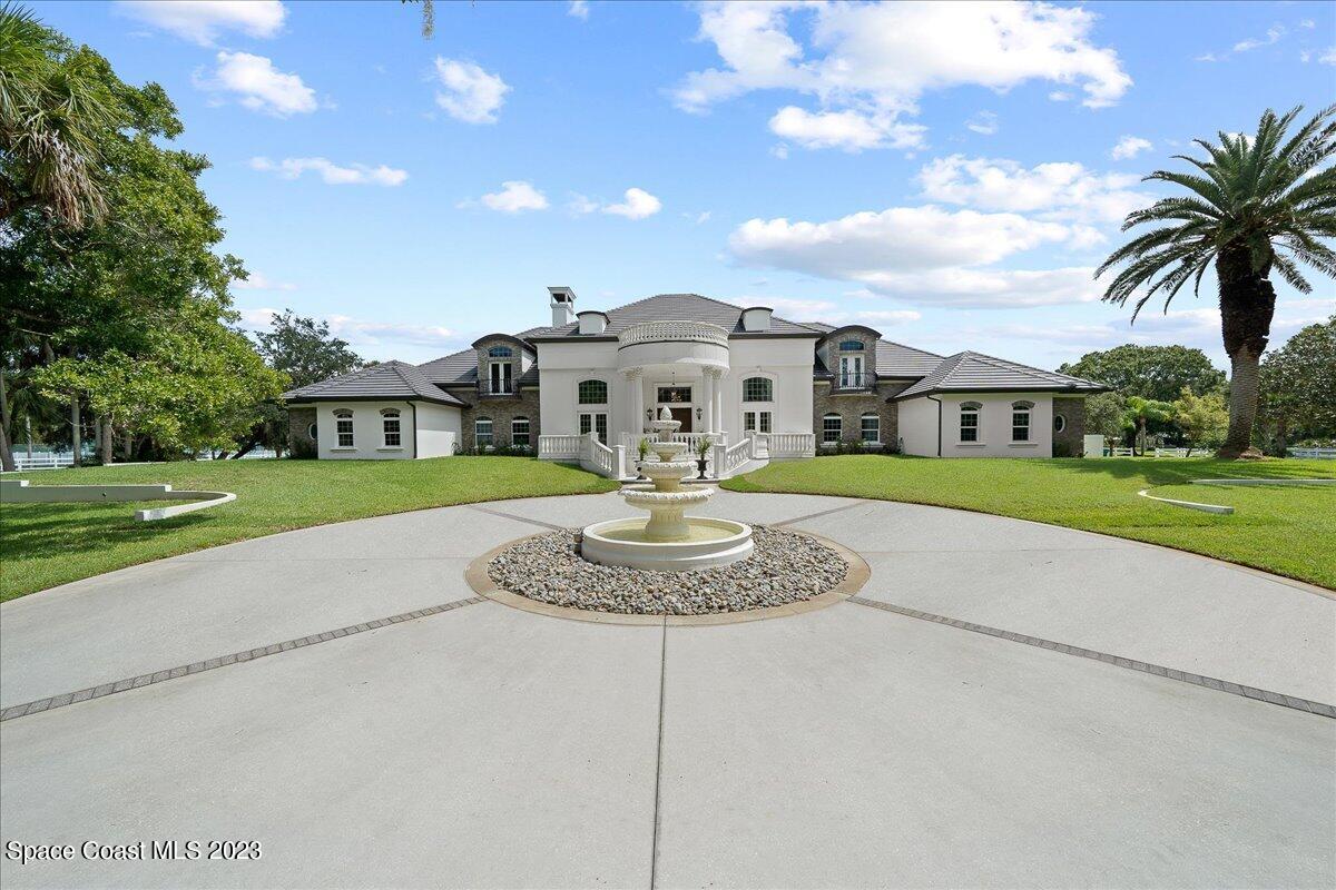 2815 Turtle Mound Road Melbourne, FL 32934 - Photo 97 of 115 a front view of a house with a garden and trees