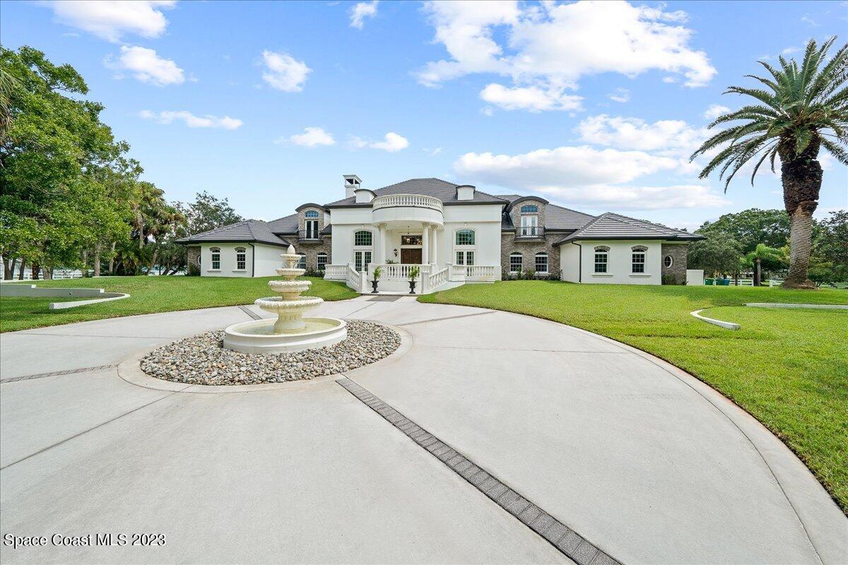 2815 Turtle Mound Road Melbourne, FL 32934 - Photo 99 of 115 a front view of a house with a yard and lake view