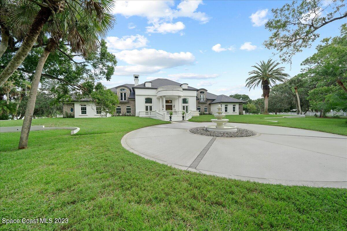 2815 Turtle Mound Road Melbourne, FL 32934 - Photo 100 of 115 a view of a house with a big yard and palm trees