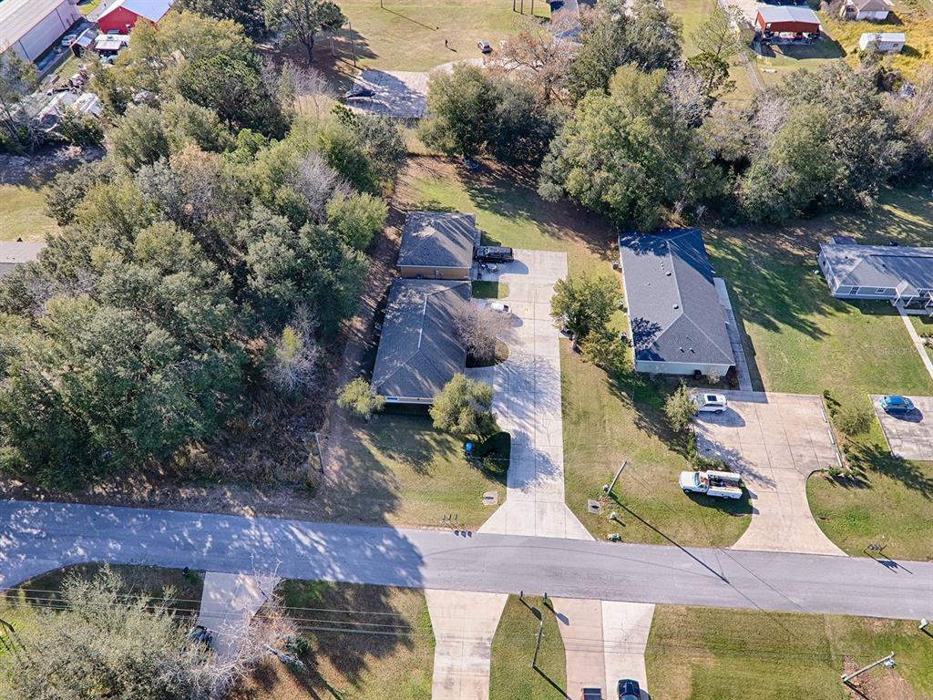 an aerial view of houses with yard