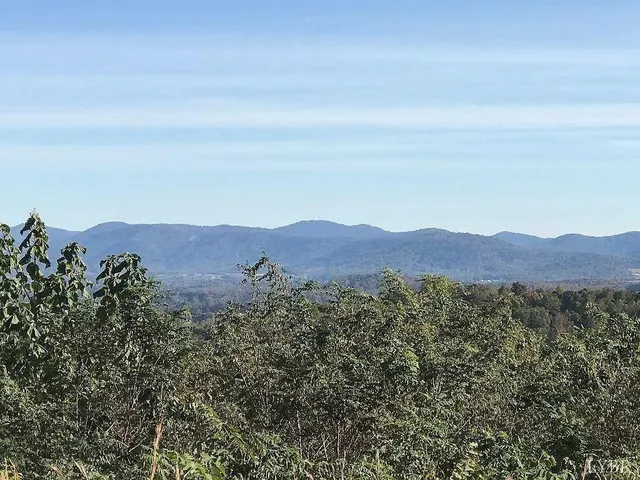 a view of a house with a mountain in the background