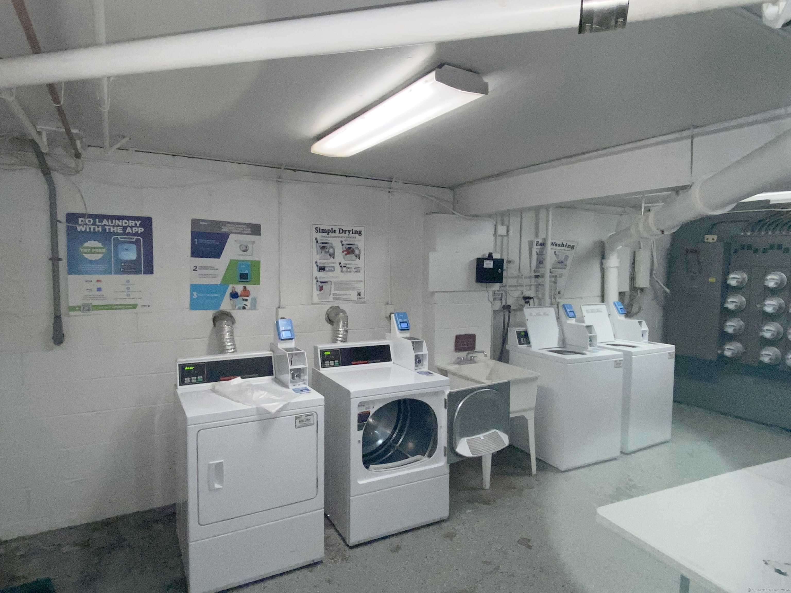 18 Prospect Street, Unit C8 Norwalk, CT 06850 - Photo 1 of 11 a utility room with dryer washer and a view of living room