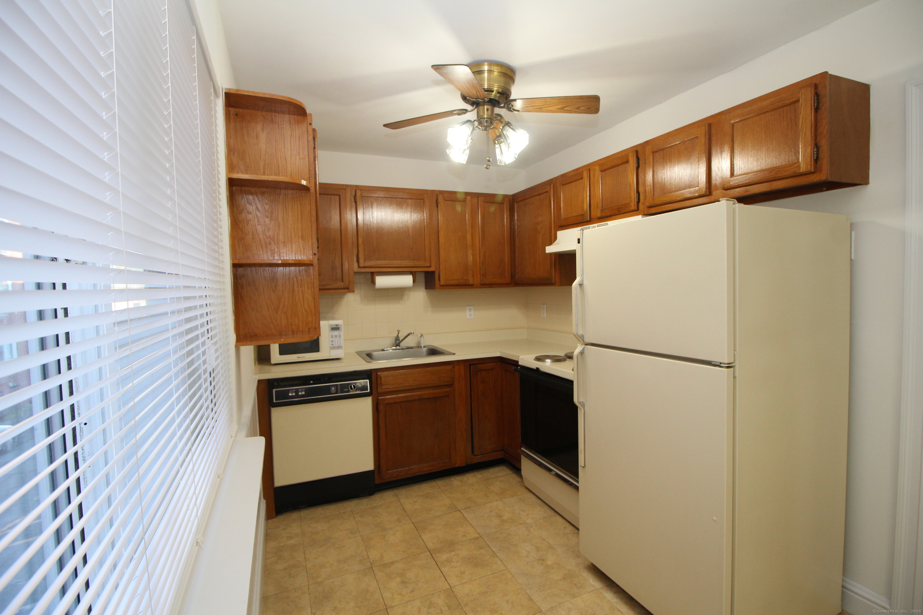 18 Prospect Street, Unit C8 Norwalk, CT 06850 - Photo 5 of 11 a kitchen with stainless steel appliances granite countertop a refrigerator and a sink