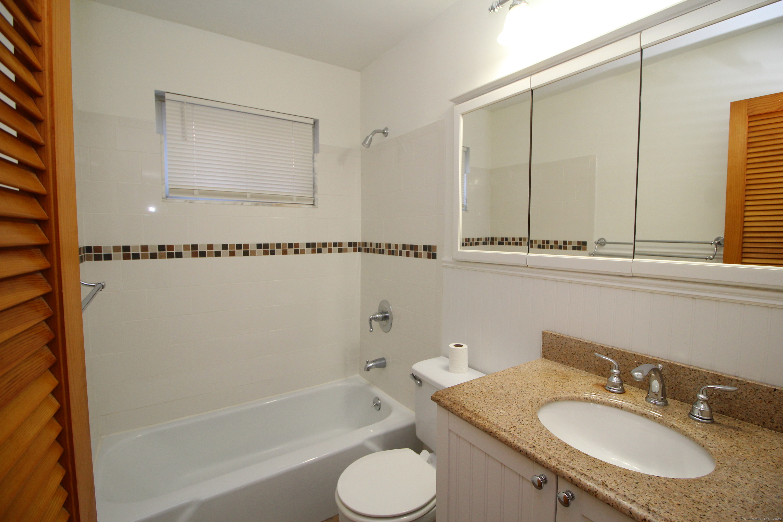 18 Prospect Street, Unit C8 Norwalk, CT 06850 - Photo 6 of 11 a bathroom with a granite countertop sink toilet and bathtub