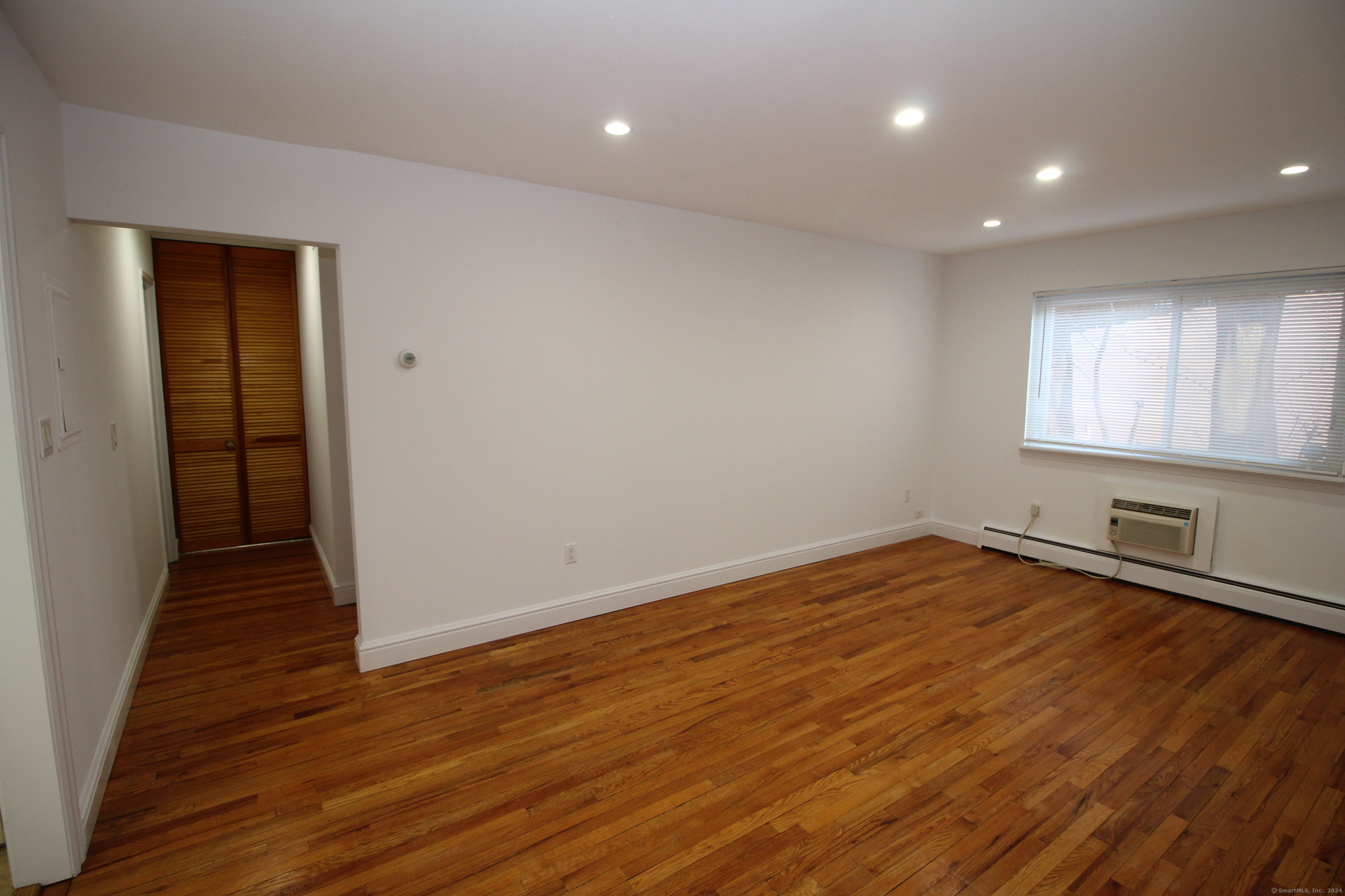 18 Prospect Street, Unit C8 Norwalk, CT 06850 - Photo 8 of 11 wooden floor in an empty room with a window
