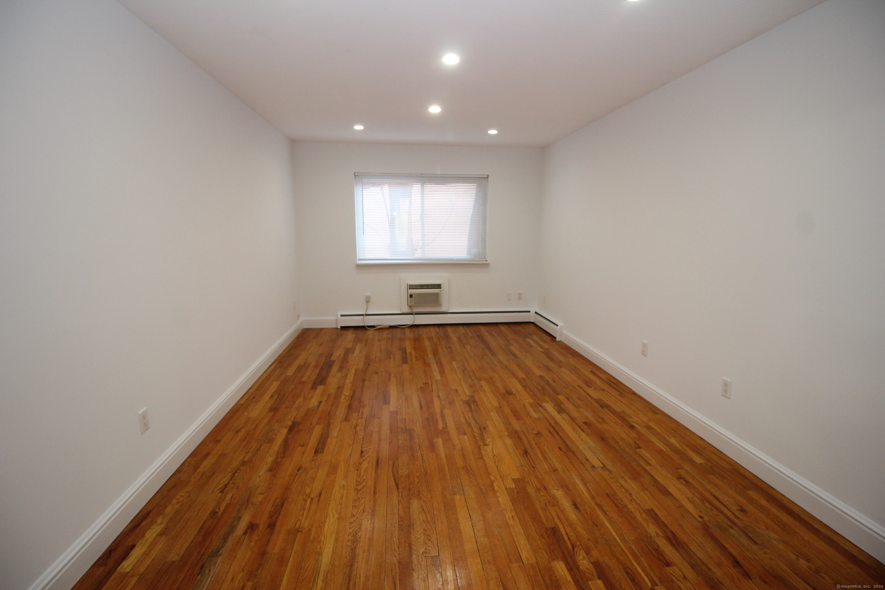 18 Prospect Street, Unit C8 Norwalk, CT 06850 - Photo 9 of 11 a view of a room with wooden floor and window