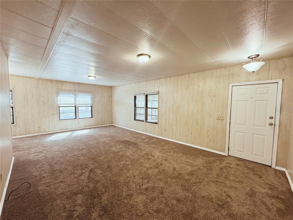 18395 Northwest 4th Terrace Citra, FL 32113 - Photo 16 of 66 an empty room with windows and ceiling fan