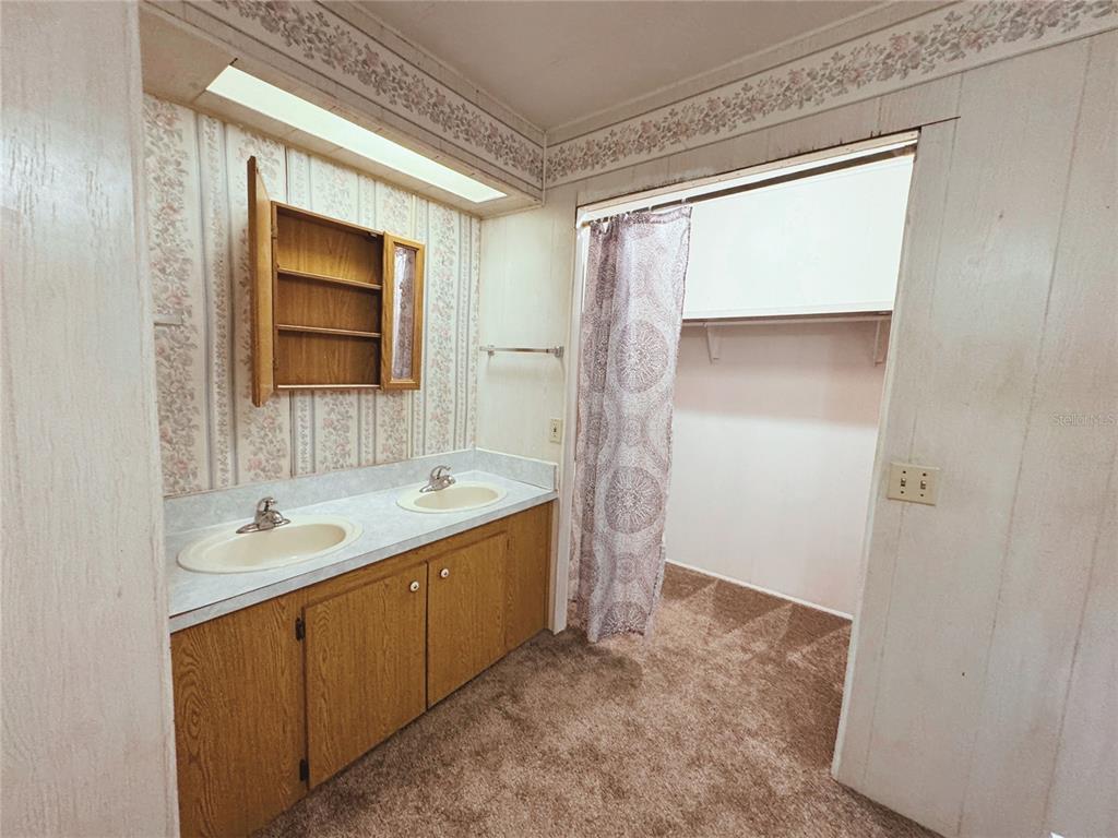 18395 Northwest 4th Terrace Citra, FL 32113 - Photo 28 of 66 a bathroom with a granite countertop sink a shower and a mirror