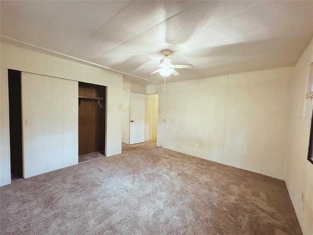 18395 Northwest 4th Terrace Citra, FL 32113 - Photo 29 of 66 an empty room with a ceiling fan and a window
