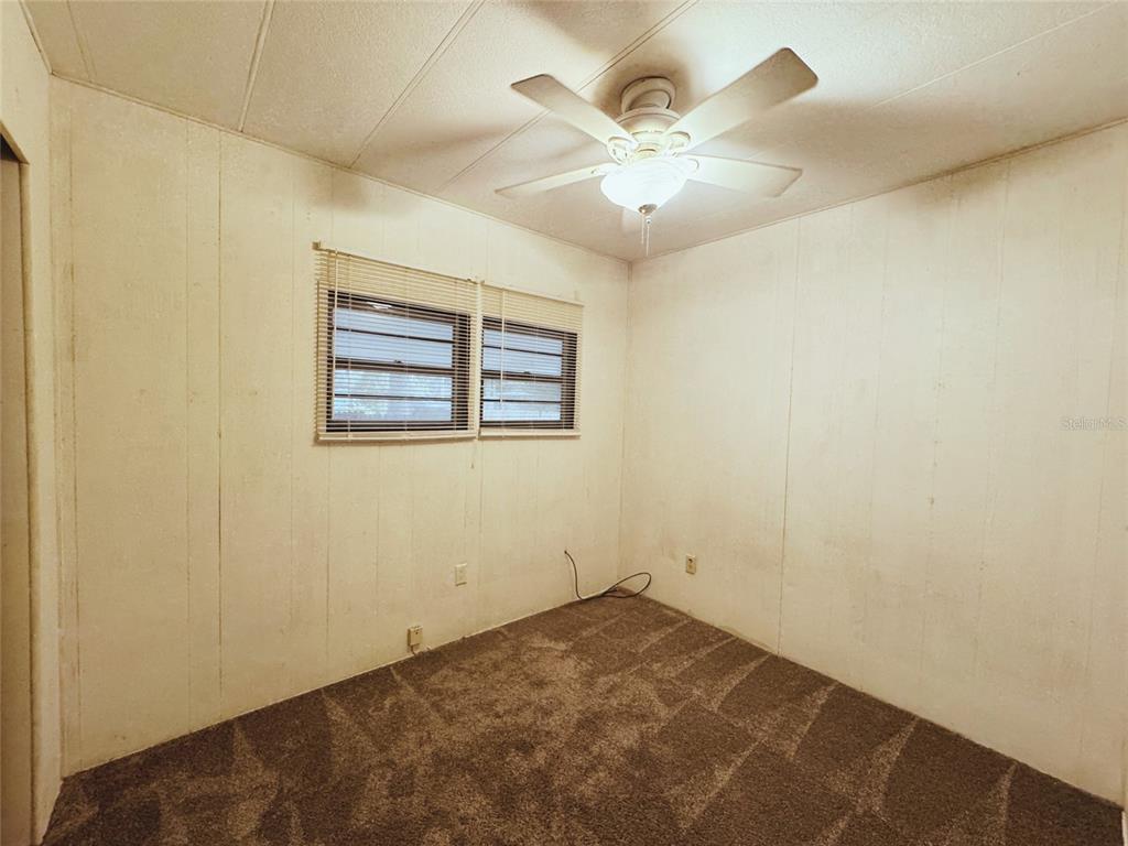 18395 Northwest 4th Terrace Citra, FL 32113 - Photo 31 of 66 an empty room with a chandelier fan and windows