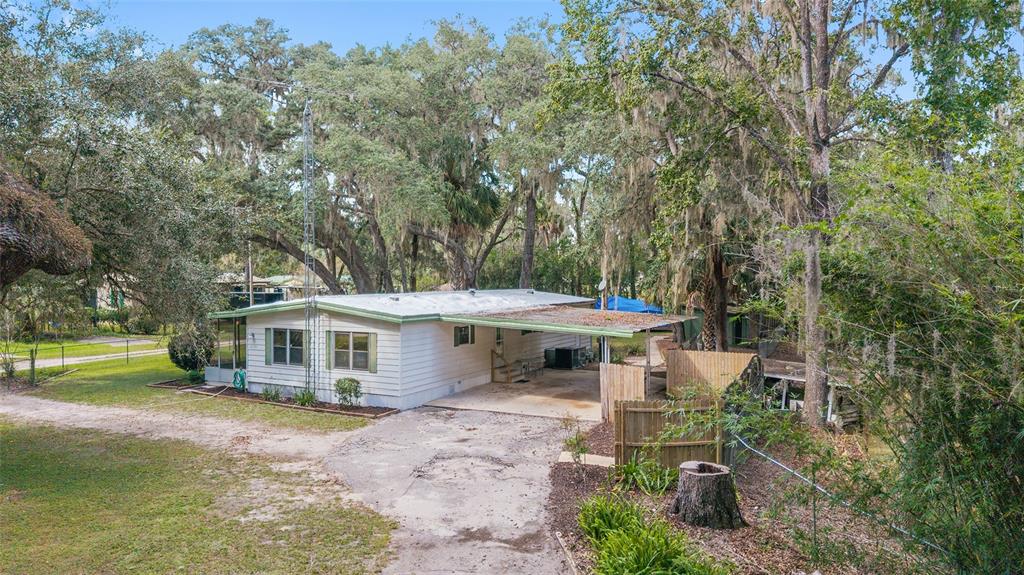 18395 Northwest 4th Terrace Citra, FL 32113 - Photo 32 of 66 a view of a house with backyard sitting area and garden