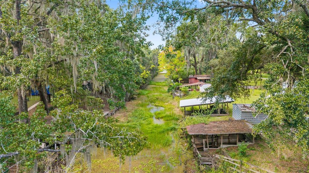 18395 Northwest 4th Terrace Citra, FL 32113 - Photo 34 of 66 a yellow house with trees in front of it