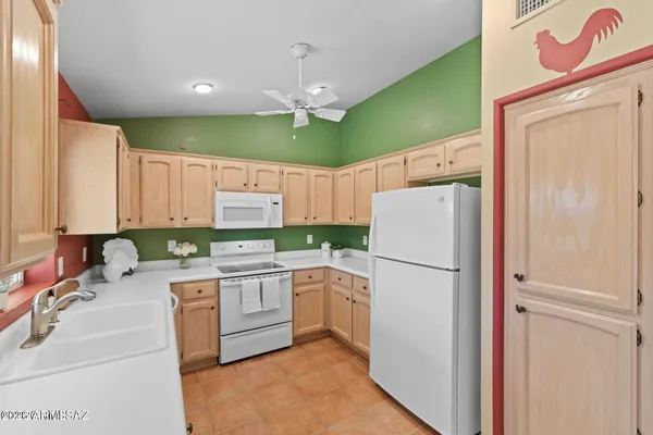 a kitchen with a refrigerator sink and stove