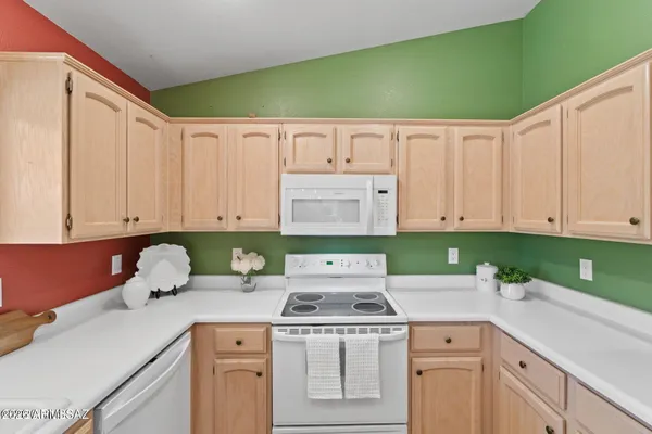 a kitchen with a sink cabinets and white appliances