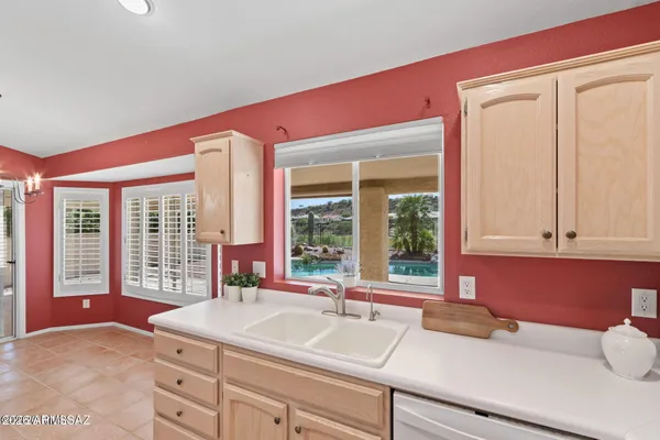 a kitchen with a sink and large window