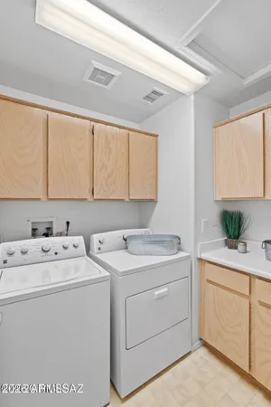 a utility room with dryer washer and a window