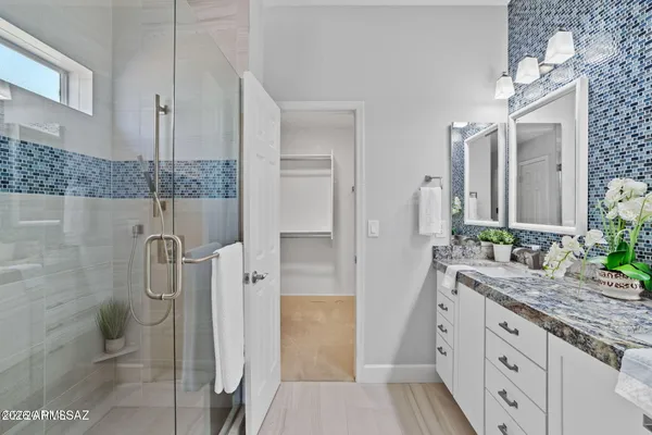 a bathroom with a double vanity sink and mirror
