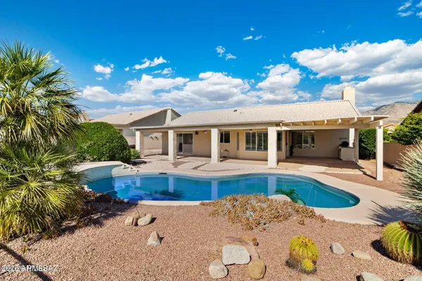 a view of a house with swimming pool and sitting area