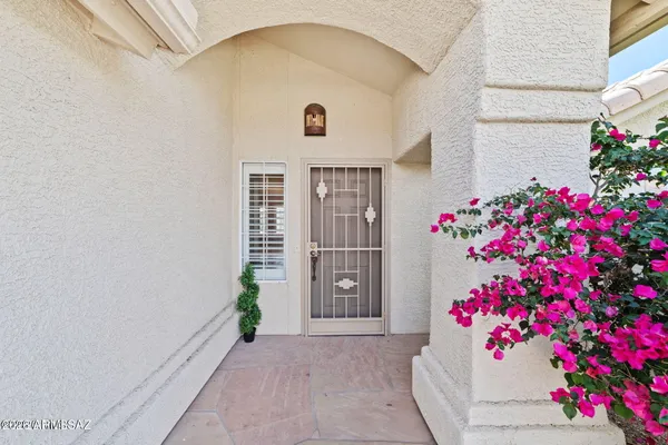 a front view of a house with flowers