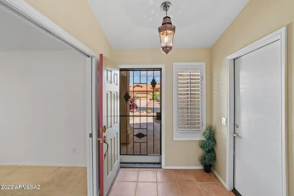 a view of a hallway to rooms and wooden floor