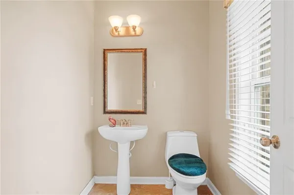 a bathroom with a sink toilet and a mirror