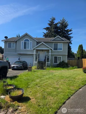 a front view of a house with a garden