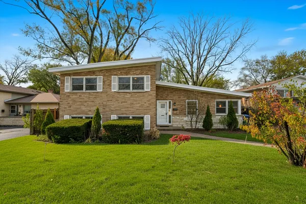 a front view of house with yard and green space