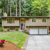 a view of a house with a yard and a garden