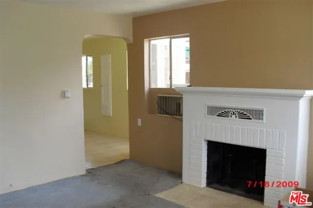 a view of an empty room with a fireplace