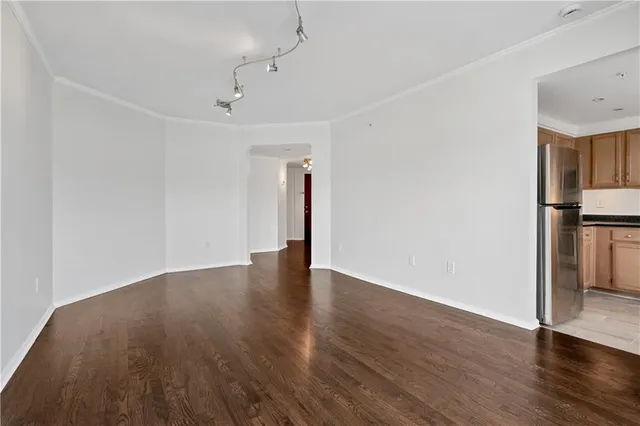 a view of an empty room with wooden floor