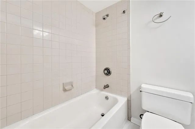 a bathroom with a bathtub and toilet