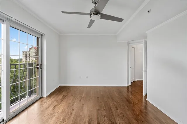 a view of room with window and wooden floor