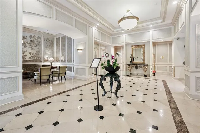 a living room with furniture a chandelier and a dining table