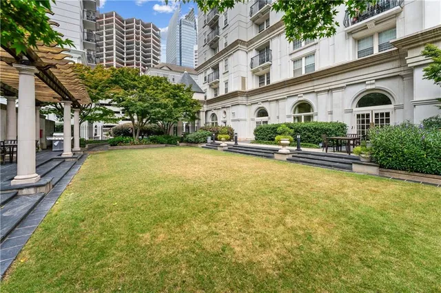 a view of a white house with a yard