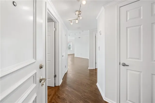a view of a hallway with wooden floor