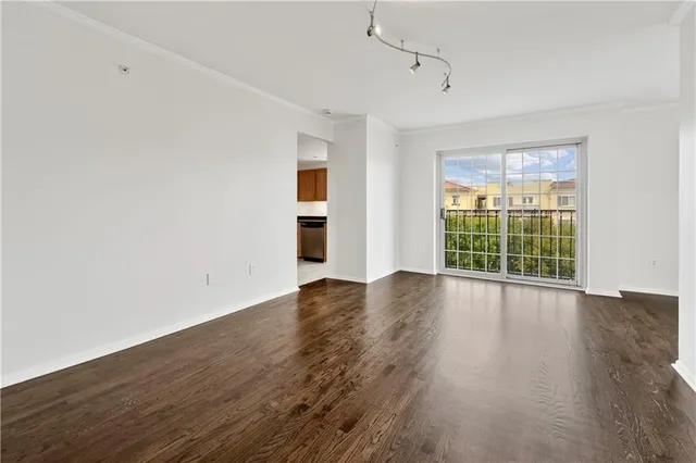 a view of wooden floor and windows in a room