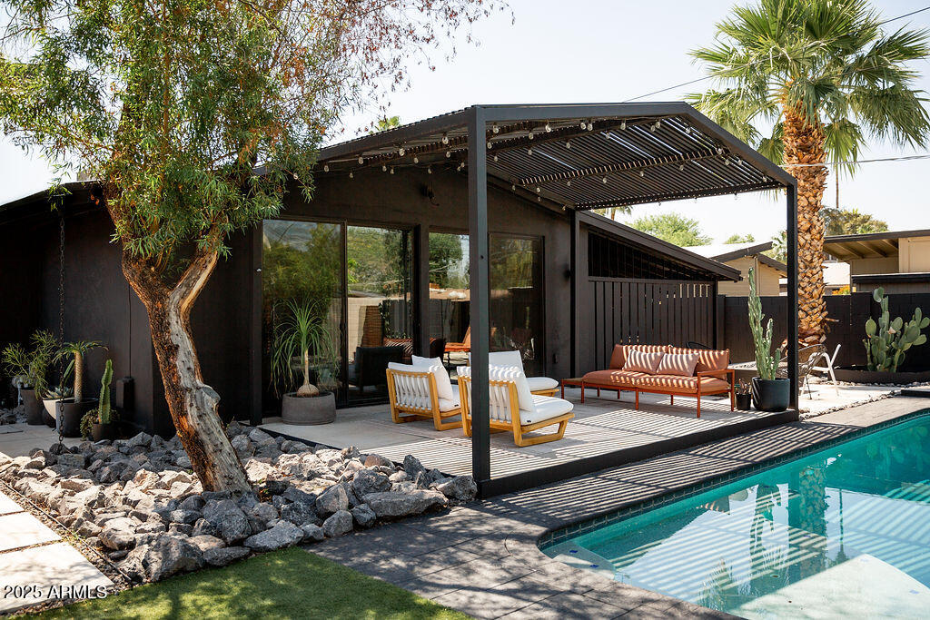 4032 North 45th Place Phoenix, AZ 85018 - Photo 3 of 38 a view of a patio with table and chairs under an umbrella