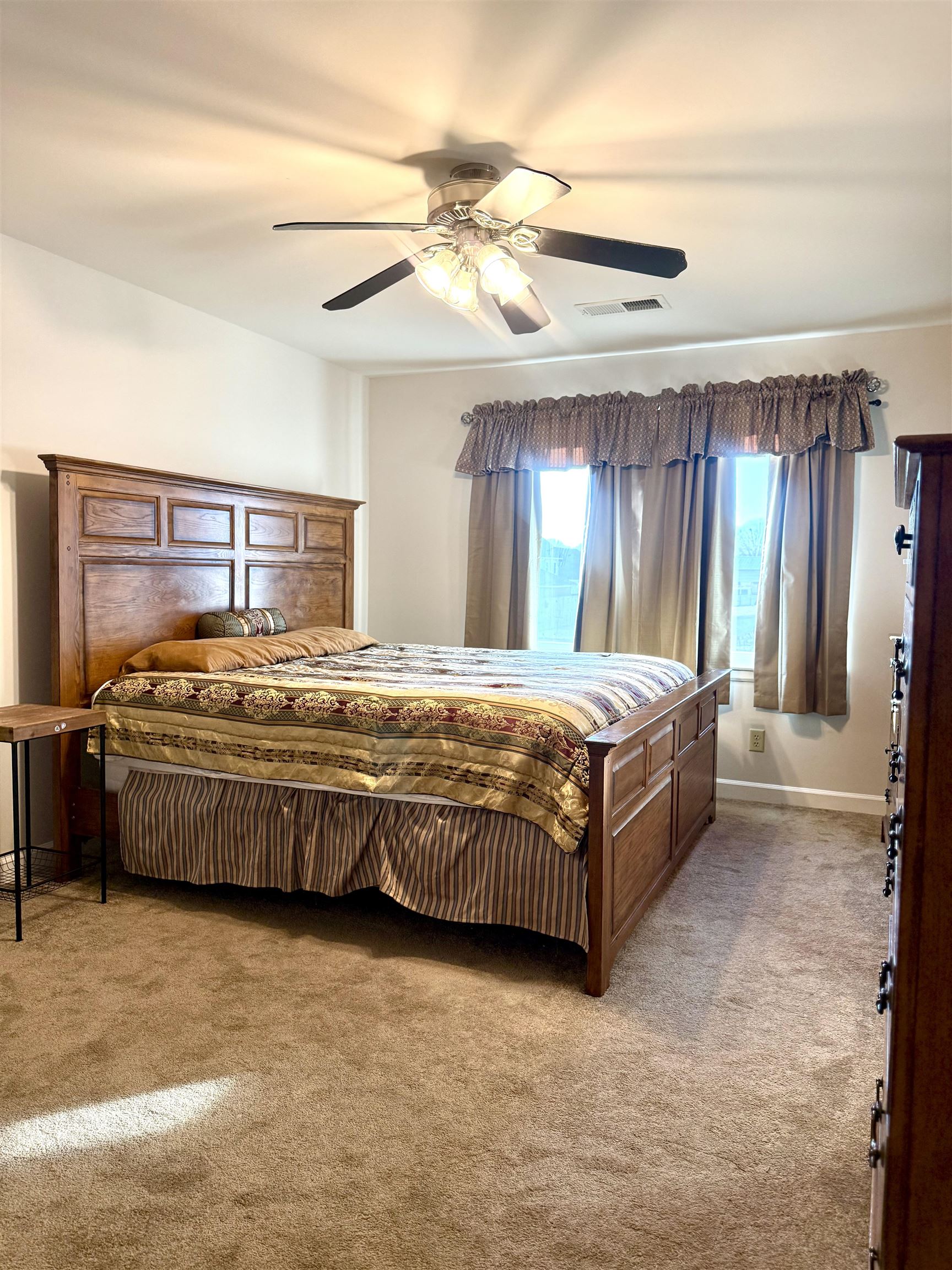 7935 Oak Spring Cove Millington, TN 38053 - Photo 24 of 39 a bedroom with a large bed and a chandelier