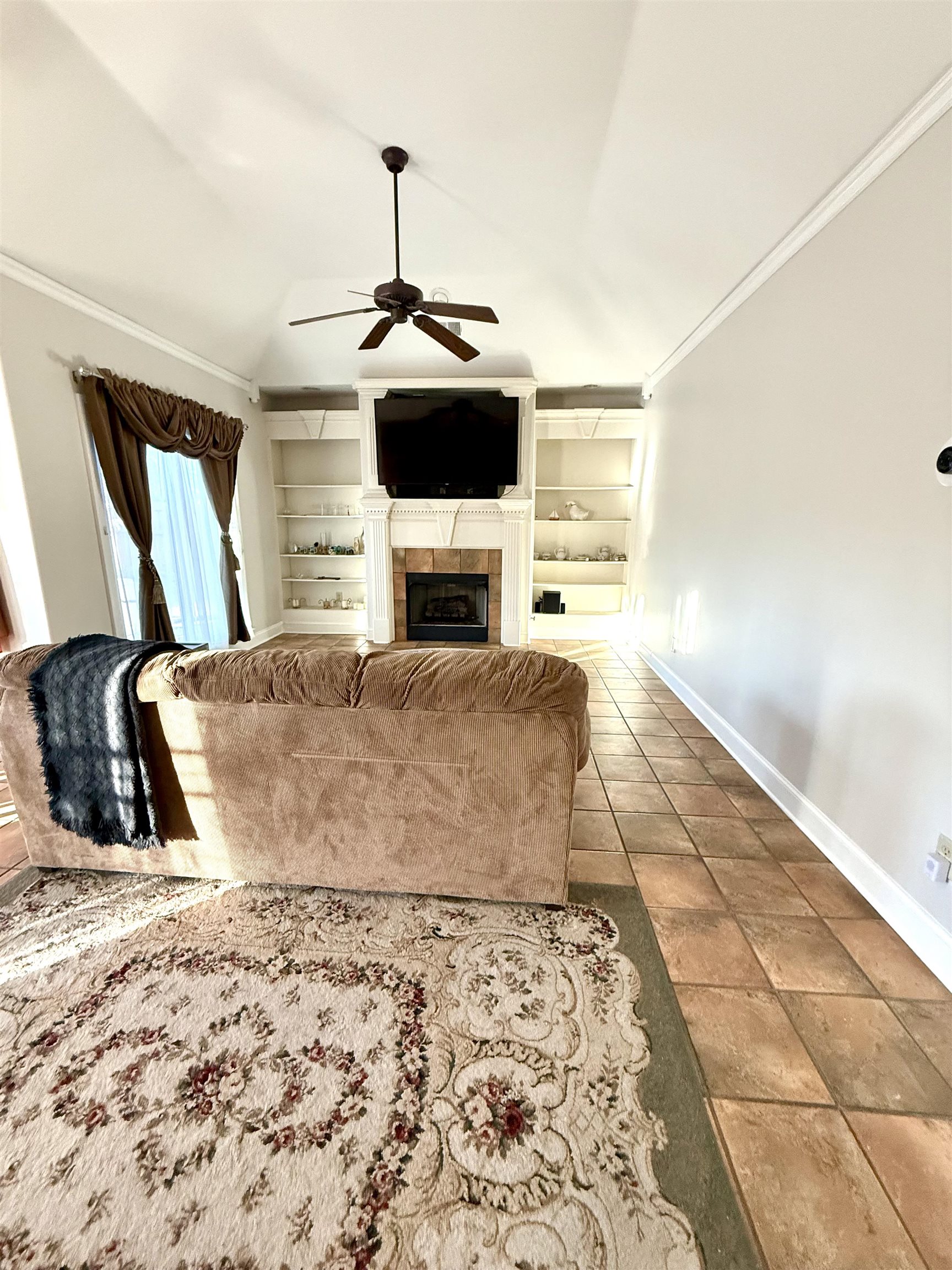 7935 Oak Spring Cove Millington, TN 38053 - Photo 10 of 39 a living room with a flat screen tv and a fireplace