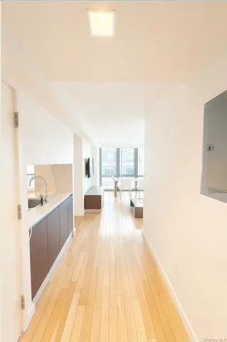 a large white kitchen with a large window