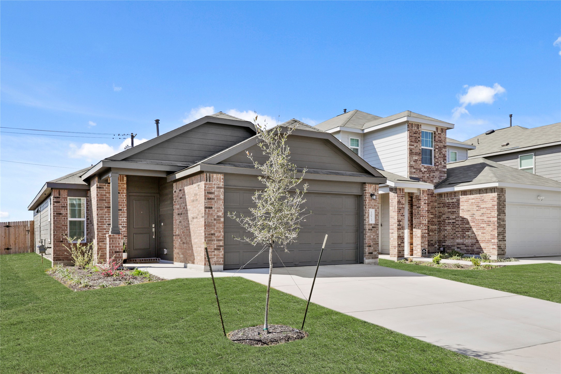 a view of a house with a yard and pathway